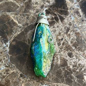 Pendant looks like a chrysalis it’s absolutely stunningly beautiful wire wrapped